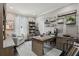 Well-lit home office with a custom desk, built-in shelving, and a comfortable reading chair at 11725 Verrazano Dr, Orlando, FL 32836