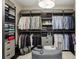 Organized walk-in closet with custom shelving, hanging rods, and a central ottoman for convenience at 11725 Verrazano Dr, Orlando, FL 32836