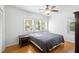 Cozy bedroom with hardwood floors, bright windows, and a ceiling fan with lighting at 1207 Cole Rd, Orlando, FL 32803