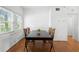 Well-lit dining room with hardwood floors, a large window, and a wood table with seating for four at 1207 Cole Rd, Orlando, FL 32803