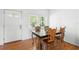 Cozy dining room with hardwood floors, a large window, and a table with four chairs at 1207 Cole Rd, Orlando, FL 32803