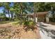 Charming single-story home with a well-manicured lawn, mature trees, and a convenient carport at 1207 Cole Rd, Orlando, FL 32803