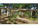 Inviting single-story home surrounded by trees, boasting a quaint entrance and lots of greenery at 1207 Cole Rd, Orlando, FL 32803