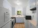 Cozy kitchen with updated appliances, ample cabinet space, and a charming view from the window at 1207 Cole Rd, Orlando, FL 32803