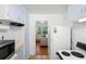 Efficient kitchen featuring white appliances and a convenient pass-through to the living area at 1207 Cole Rd, Orlando, FL 32803