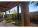 Cozy covered patio with a textured support beam and a glimpse of the natural surroundings and the fenced backyard at 1207 Cole Rd, Orlando, FL 32803