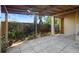 Covered patio with a ceiling fan, providing a versatile outdoor space and backyard access to the fenced yard and garden area at 1207 Cole Rd, Orlando, FL 32803