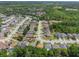 Neighborhood aerial view showing houses with mature trees and a pond in the distance at 122 Oak View Pl, Sanford, FL 32773