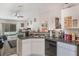 Well-lit kitchen with a view of the living area and pool, enhancing the home's open feel at 122 Oak View Pl, Sanford, FL 32773