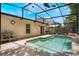 Backyard pool with a screened enclosure, featuring chairs for relaxing and a bright blue sky at 122 Oak View Pl, Sanford, FL 32773