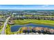 Aerial view of a home located on a large pond in a community with a golf course at 13090 Bromborough Dr, Orlando, FL 32832