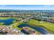 Picturesque aerial view of a golf course community with lakes, lush greenery, and stylish homes at 13090 Bromborough Dr, Orlando, FL 32832
