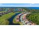 Stunning aerial view of a community with winding lakes, lush golf courses, and beautiful homes at 13090 Bromborough Dr, Orlando, FL 32832