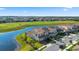 Aerial view of a home with solar panels on the roof, located on a waterfront property next to a golf course at 13090 Bromborough Dr, Orlando, FL 32832