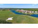 Picturesque aerial view of the community featuring waterfront homes with a golf course in the background at 13090 Bromborough Dr, Orlando, FL 32832