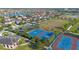 Aerial view of community basketball courts, surrounded by a neighborhood, tennis courts, and a playground at 13090 Bromborough Dr, Orlando, FL 32832