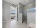 Beautiful bathroom with a glass enclosed shower and a door to the bedroom allowing ample light in the space at 13090 Bromborough Dr, Orlando, FL 32832
