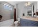 Modern bathroom with a shower and tub combination and granite counters at 13090 Bromborough Dr, Orlando, FL 32832