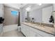 Bright bathroom with a double sink vanity with granite counter tops, and a shower and bath combo at 13090 Bromborough Dr, Orlando, FL 32832