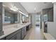 Stylish bathroom with double sinks, gray cabinets, and neutral-toned decor at 13090 Bromborough Dr, Orlando, FL 32832