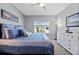 Bedroom with blue bedding, ceiling fan, and window at 13090 Bromborough Dr, Orlando, FL 32832