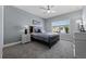 Comfortable bedroom with carpet, a ceiling fan, and a view of the neighborhood at 13090 Bromborough Dr, Orlando, FL 32832