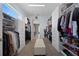 An organized closet with storage shelves and drawers, with a bench at the center of the room at 13090 Bromborough Dr, Orlando, FL 32832