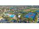 Aerial shot showcasing the community amenities: pool, playground, tennis, and basketball courts in a residential neighborhood at 13090 Bromborough Dr, Orlando, FL 32832