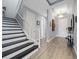 Staircase and entryway with chandelier and wood floors leading into the home at 13090 Bromborough Dr, Orlando, FL 32832