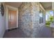 Charming front porch with stone accents, a welcoming entrance, and a brick-paved walkway at 13090 Bromborough Dr, Orlando, FL 32832