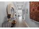 Inviting hallway with wood floors, stylish console table, and decorative mirror create an elegant entrance at 13090 Bromborough Dr, Orlando, FL 32832