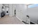 Hallway with carpet flooring that leads to multiple rooms with lots of natural light at 13090 Bromborough Dr, Orlando, FL 32832