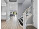 Hallway with stairway featuring black treads and white risers leading to the upper level at 13090 Bromborough Dr, Orlando, FL 32832