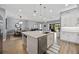 Open-concept kitchen with island and breakfast bar overlooking the dining and living spaces at 13090 Bromborough Dr, Orlando, FL 32832