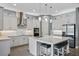 Bright kitchen featuring white cabinets, stainless appliances, and a large island with seating at 13090 Bromborough Dr, Orlando, FL 32832