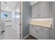 Convenient laundry room with white cabinets, countertop space, and modern washer and dryer at 13090 Bromborough Dr, Orlando, FL 32832