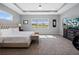 Elegant primary bedroom with carpet, recessed lights, TV and scenic backyard views at 13090 Bromborough Dr, Orlando, FL 32832