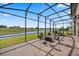 Spacious screened-in patio area with outdoor seating, perfect for enjoying the scenic waterfront view at 13090 Bromborough Dr, Orlando, FL 32832