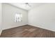 Bright bedroom featuring a ceiling fan and light-filled window, complemented by wood flooring at 133 Reserve Cir # 109, Oviedo, FL 32765