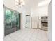 Bright kitchen with white cabinets, appliances, and a sliding glass door to patio at 133 Reserve Cir # 109, Oviedo, FL 32765