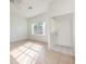 Bright living room with neutral tile flooring, ceiling fan, and natural light at 133 Reserve Cir # 109, Oviedo, FL 32765