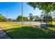 Well-maintained tennis court with a sturdy fence and lush greenery at 133 Reserve Cir # 109, Oviedo, FL 32765