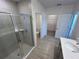 Clean, modern bathroom featuring a glass-enclosed shower, tile walls, and convenient access to closet and toilet at 141 Addle Hill Ct, Deland, FL 32720
