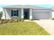 Charming single-story home featuring a well-manicured lawn, neutral paint and attached two car garage at 141 Addle Hill Ct, Deland, FL 32720