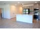 Bright modern kitchen with stainless steel appliances, island and tile flooring perfect for cooking and entertaining at 141 Addle Hill Ct, Deland, FL 32720