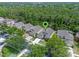 Aerial view showcasing the property's location surrounded by lush greenery and neighboring homes at 14750 Hartford Run Dr, Orlando, FL 32828