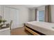 Cozy bedroom featuring a bed, closet, window, and desk is perfect for relaxation and productivity at 14750 Hartford Run Dr, Orlando, FL 32828