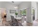 Modern dining room featuring a contemporary light fixture and sliding glass doors to the lanai at 14750 Hartford Run Dr, Orlando, FL 32828