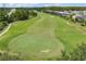 Scenic golf course with a lush green fairway, a sand trap and mature landscaping in a beautiful community at 14750 Hartford Run Dr, Orlando, FL 32828