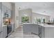 Beautiful kitchen featuring stainless appliances, gray cabinets, and stone countertops at 14750 Hartford Run Dr, Orlando, FL 32828
